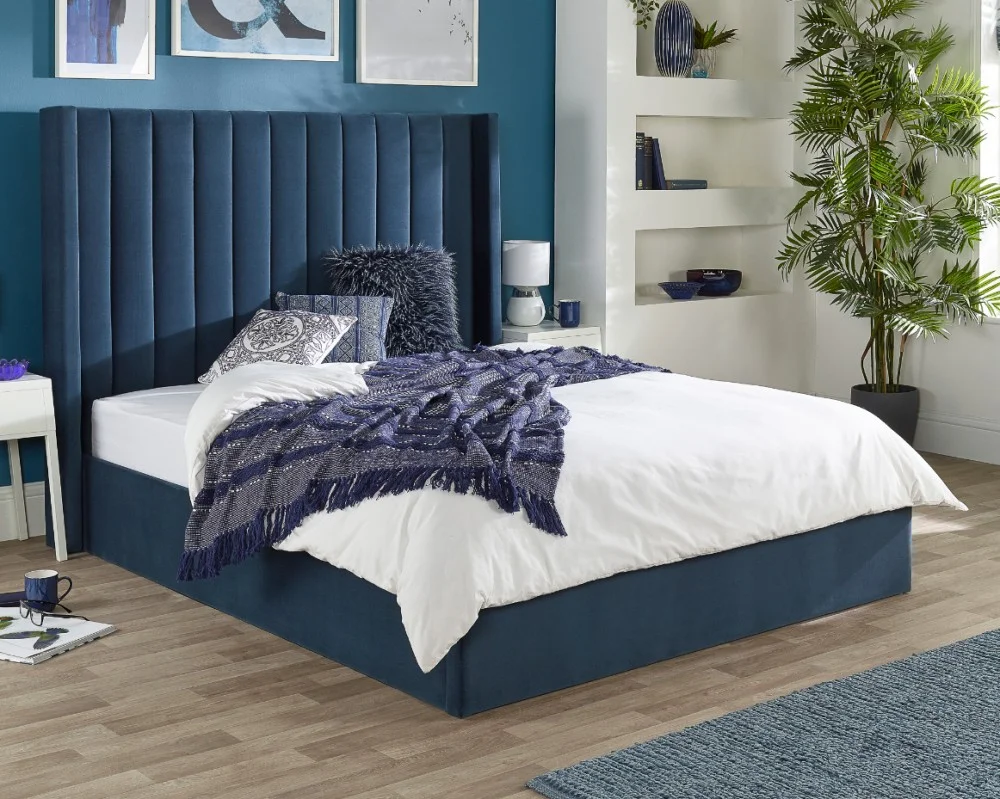 Product photograph of Aspire Maxi Winged Headboard Blue Velvet Ottoman Storage Bed from Aspire Furniture LTD