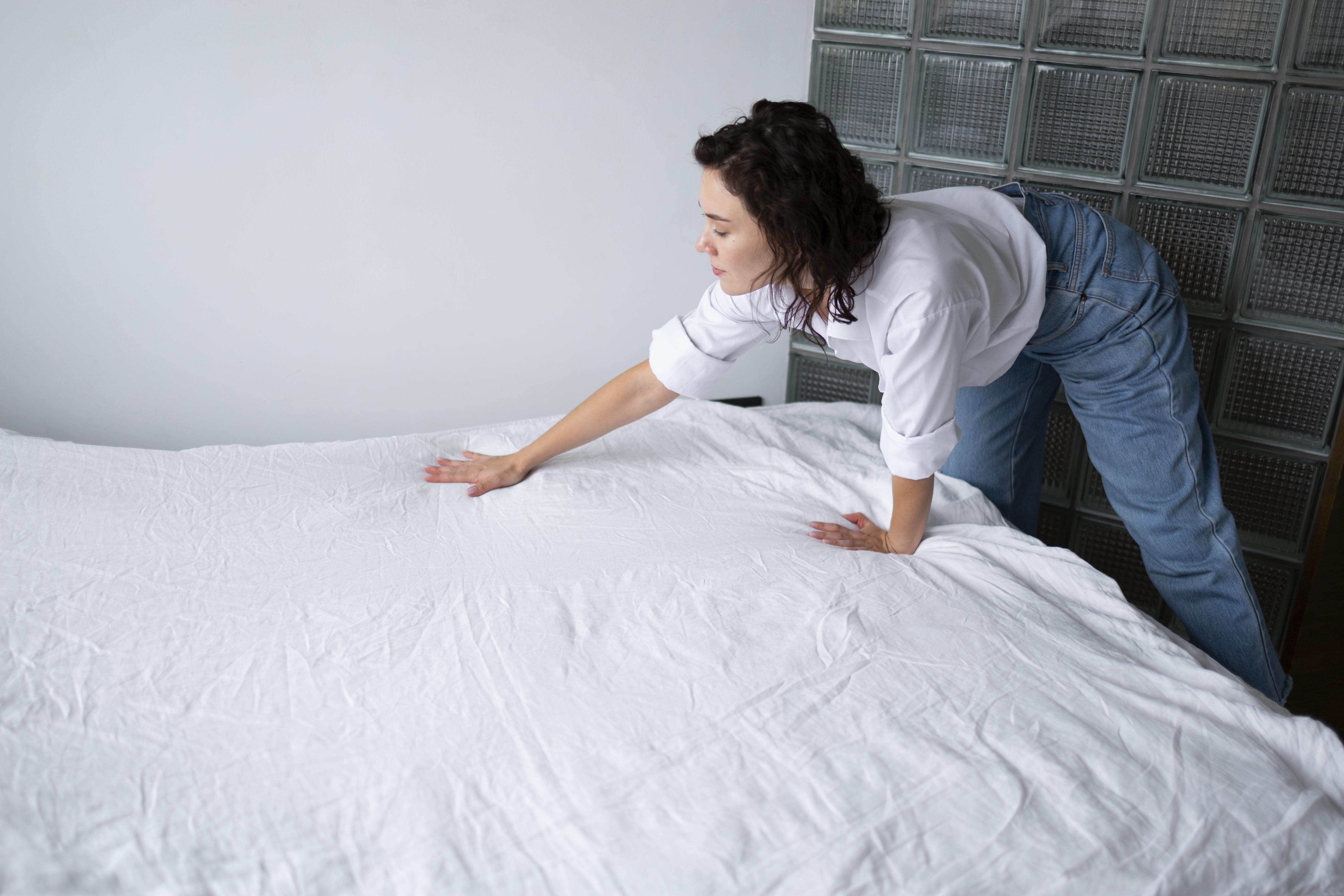 woman making bed