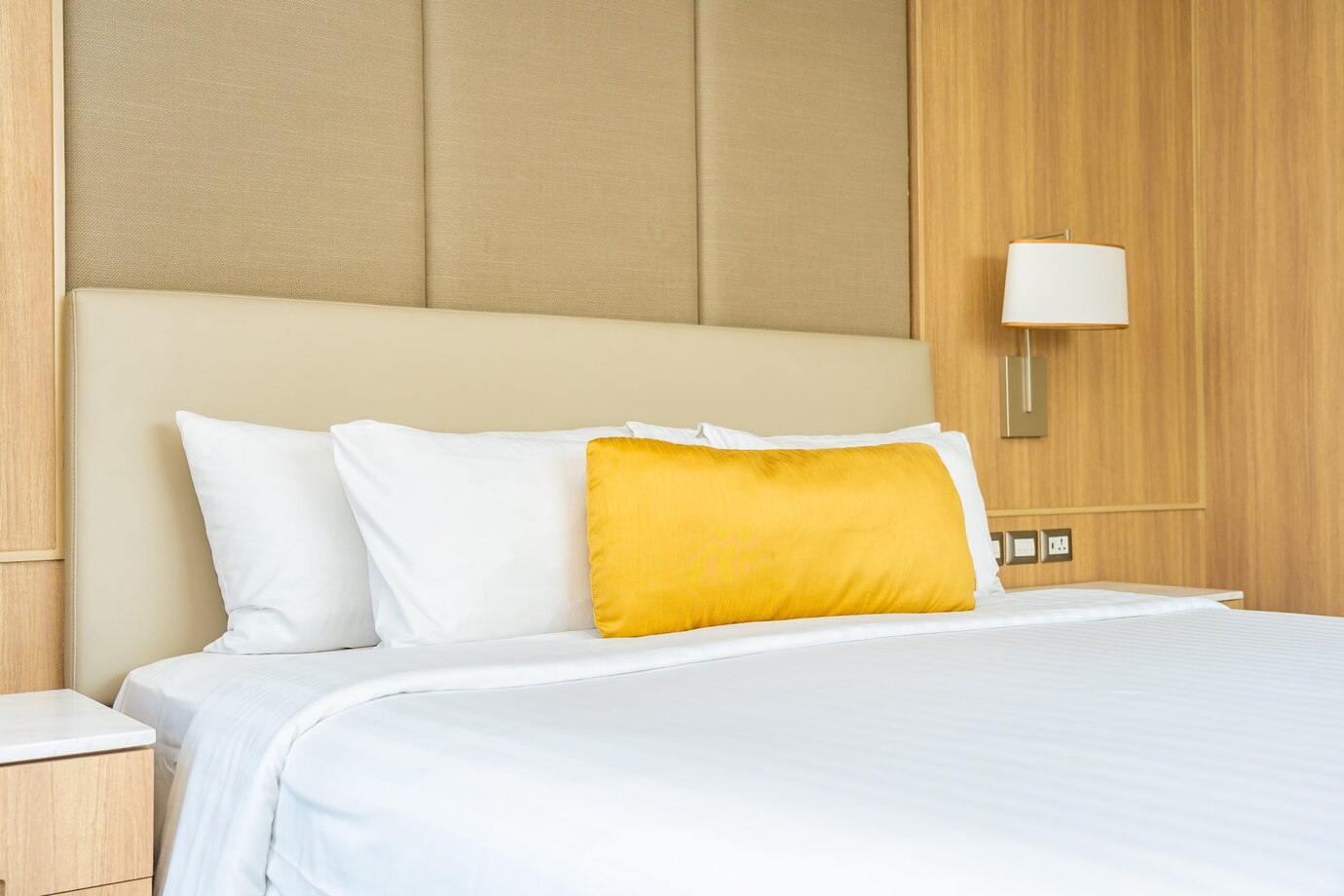 headboard with yellow and white pillow